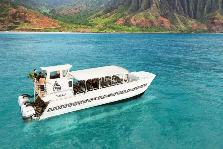 a boat on a body of water with a mountain in the background