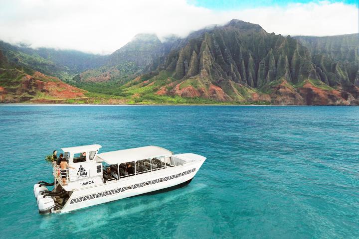 a boat on a body of water with a mountain in the background