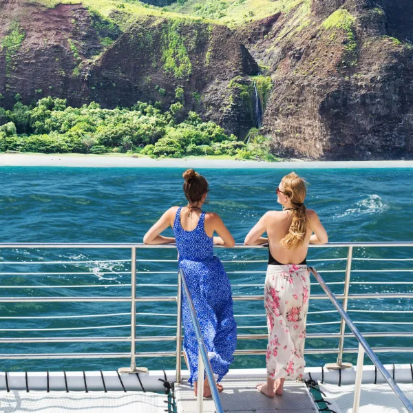 a group of people standing in front of a mountain