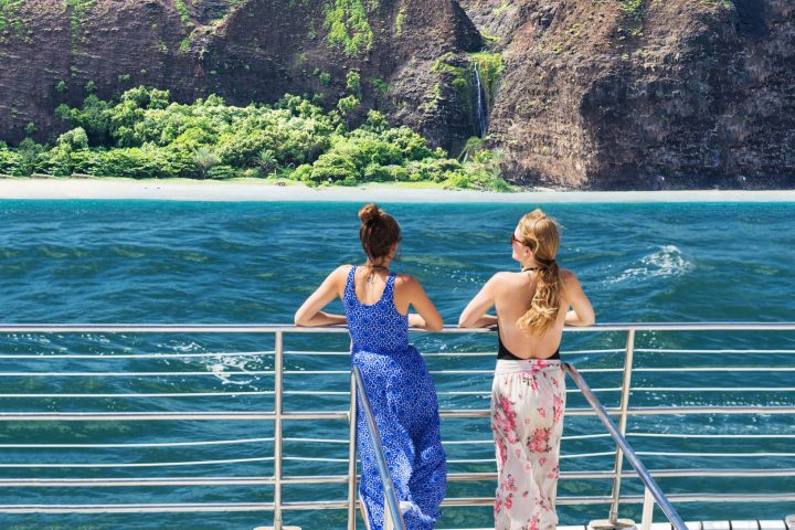 a group of people standing in front of a mountain