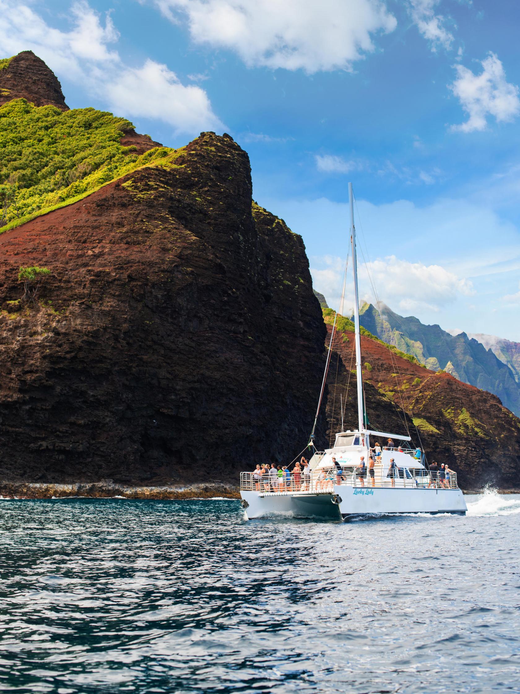 a small boat in a body of water with a mountain in the background