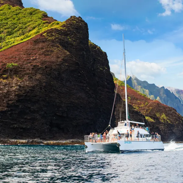 a small boat in a body of water with a mountain in the background