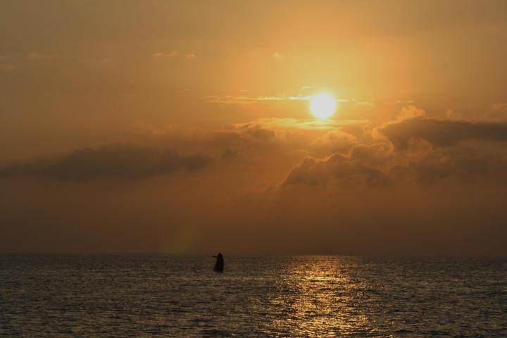 a sunset over a body of water