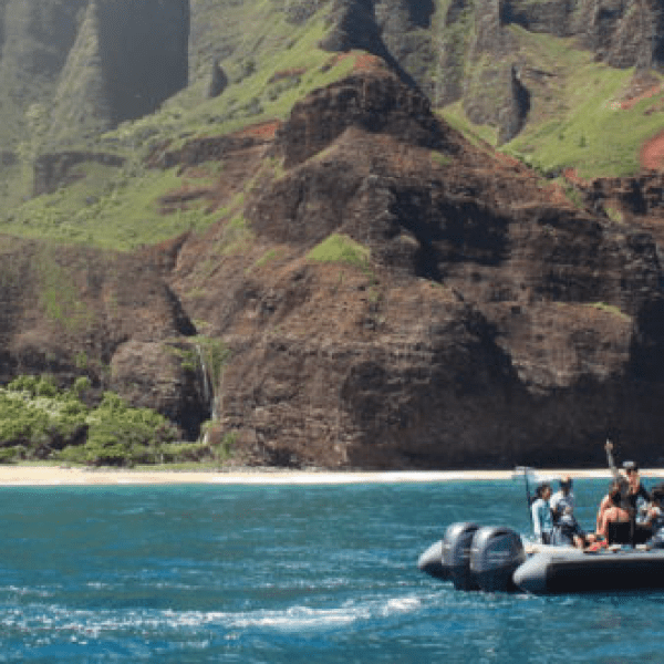 a small boat in a body of water with a mountain in the background