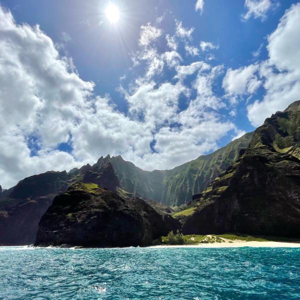 a large body of water with a mountain in the background