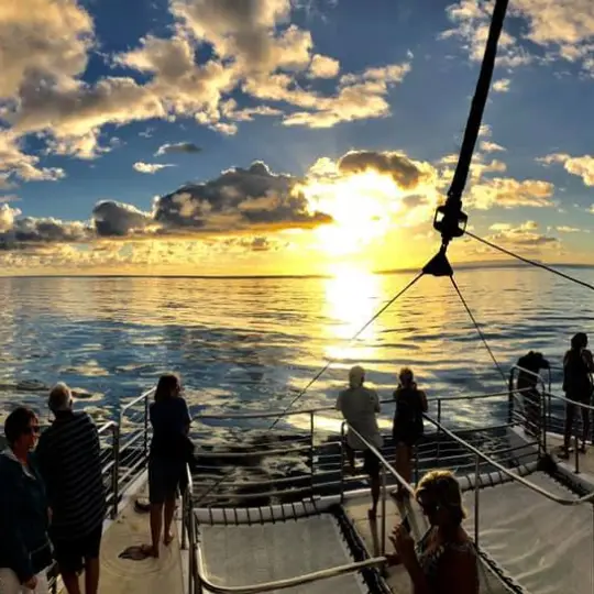 a group of people in a boat on a body of water