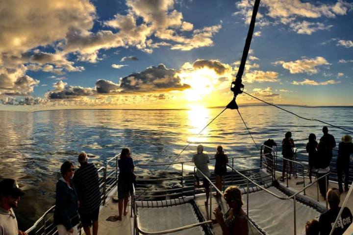 a group of people in a boat on a body of water