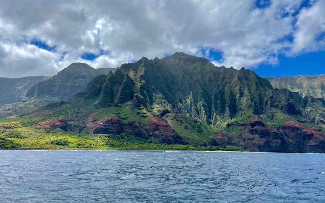 Kauai-Sea-Tours-67 a large body of water with a mountain in the background
