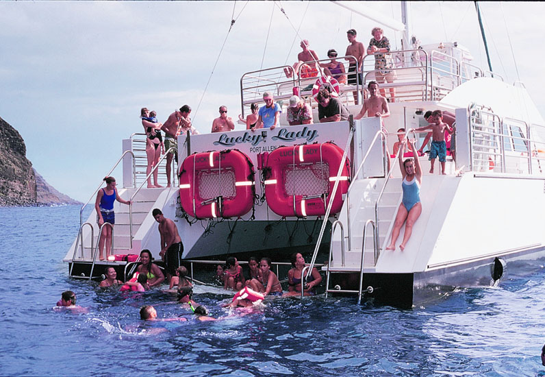 NaPali_slides-waterslide a group of people riding on the back of a boat