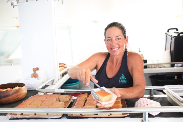 a woman cooking food in a kitchen