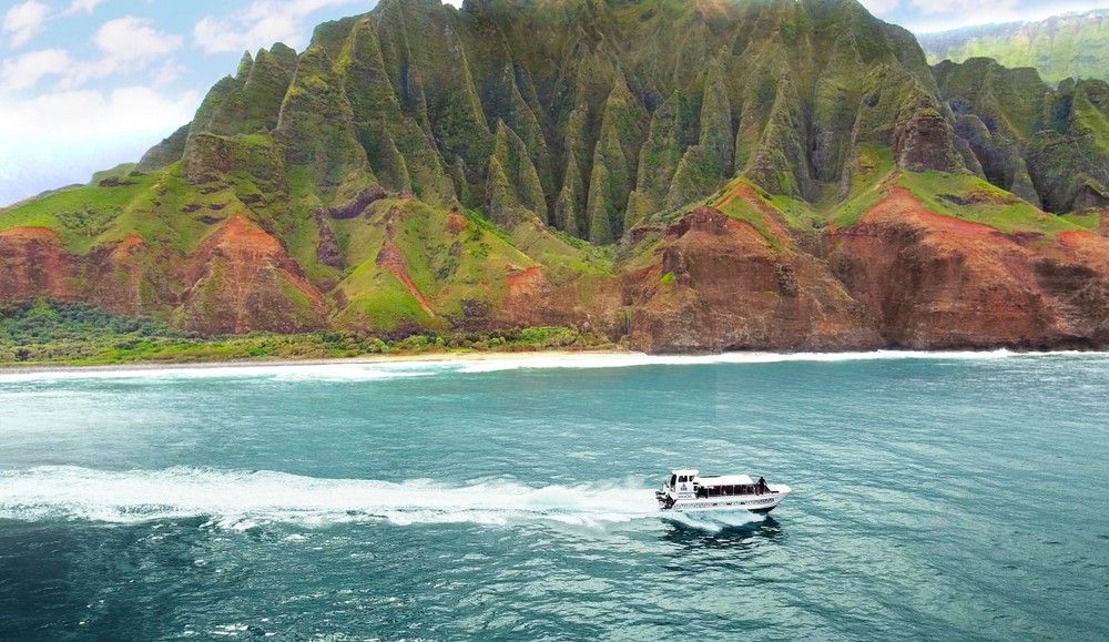 a small boat in a body of water with a mountain in the background