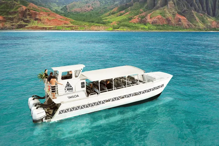 a boat on a body of water with a mountain in the background