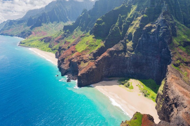 a view of water and Nā Pali Coast State Park in the background