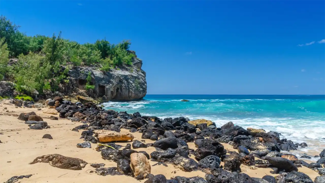 Rocks & cliff along Shipwrecks Beach in Kauai, Kauai Sea Tours