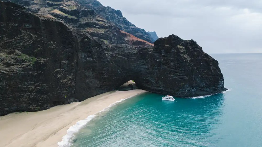 Explore Kauai's hidden beaches and sea caves by boat.